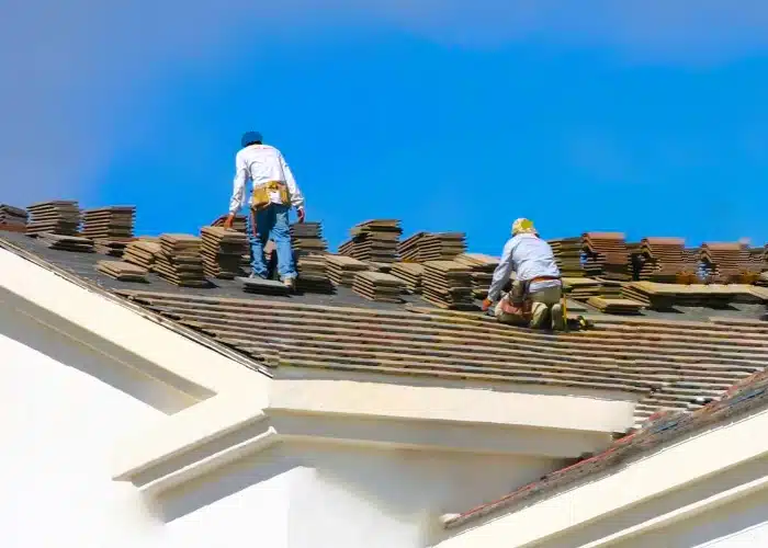 Roofers installing a residential tile roof